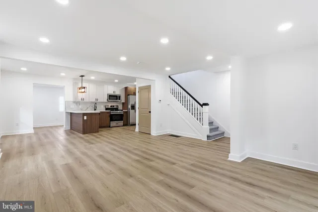 a view of kitchen with furniture and wooden floor