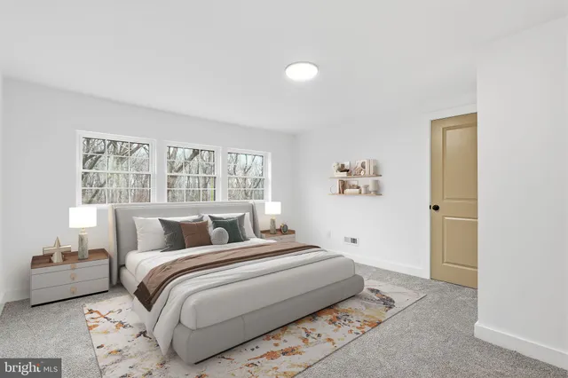 a bedroom with a large bed and a window