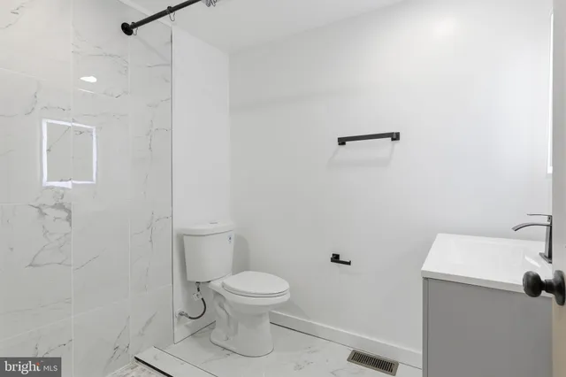a white toilet sitting next to a bathroom sink