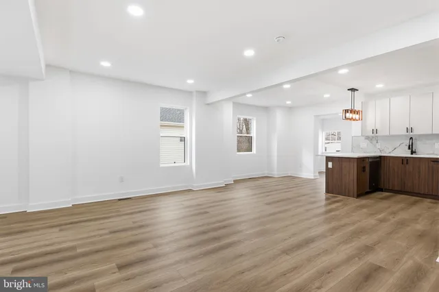 a view of kitchen with granite countertop cabinets and wooden floor