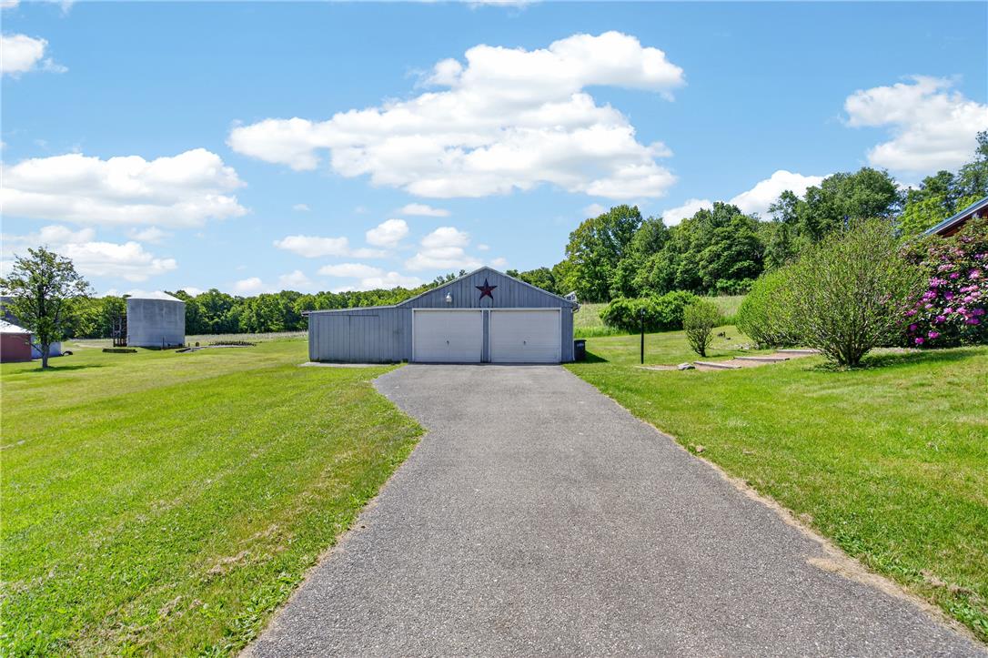 62 Stoney Road Tamaqua, PA 18252 - Photo 49 of 61 A long paved driveway leads to a versatile garage structure amidst verdant grounds and mature trees.