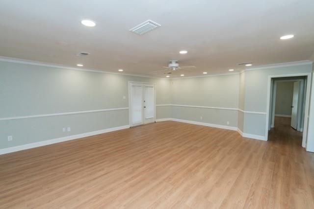 106 Mapleleaf Lane Coppell, TX 75019 - Photo 13 of 36 Spacious room featuring wood-finish flooring, recessed lighting, a ceiling fan, crown molding, and two-tone wall paint with wainscoting