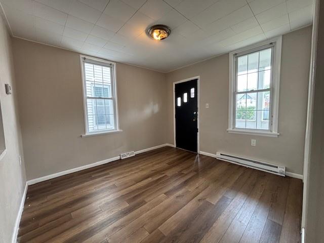 634 Sixth Street Pitcairn, PA 15140 - Photo 2 of 12 an empty room with wooden floor and windows