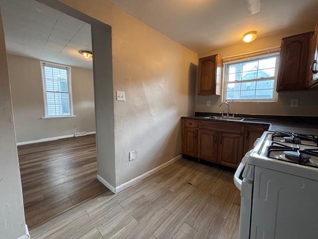 634 Sixth Street Pitcairn, PA 15140 - Photo 4 of 12 a kitchen with granite countertop a stove a sink and a microwave