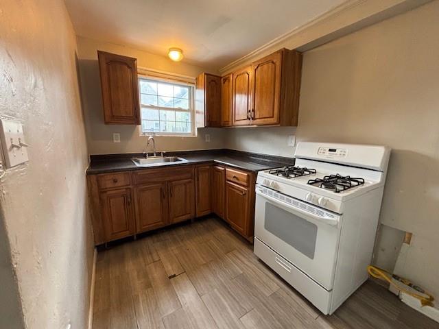 634 Sixth Street Pitcairn, PA 15140 - Photo 5 of 12 a kitchen with a stove a sink and wooden floor