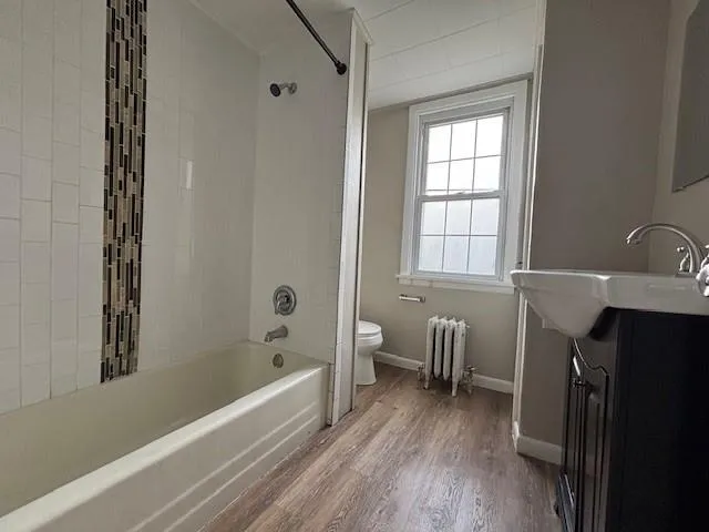 a bathroom with a bathtub and a window