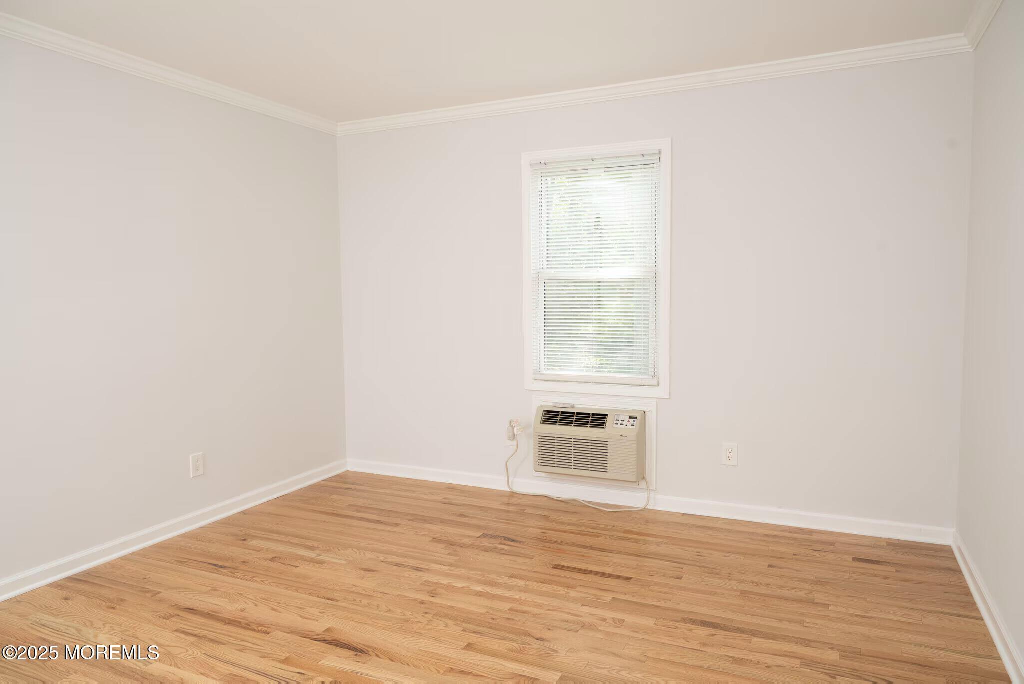 1218 Allaire Road, Unit 1908B Spring Lake, NJ 07762 - Photo 2 of 10 a view of empty room with wooden floor and fan