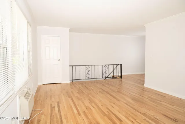 a view of a room with wooden floor