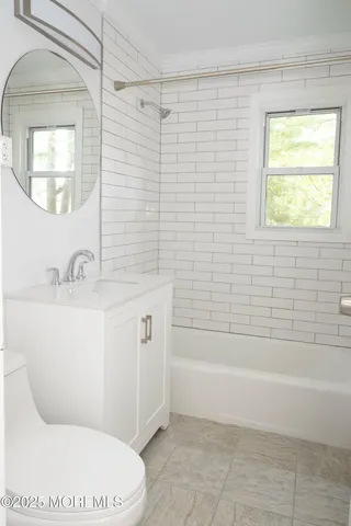 a bathroom with a sink a toilet and bathtub