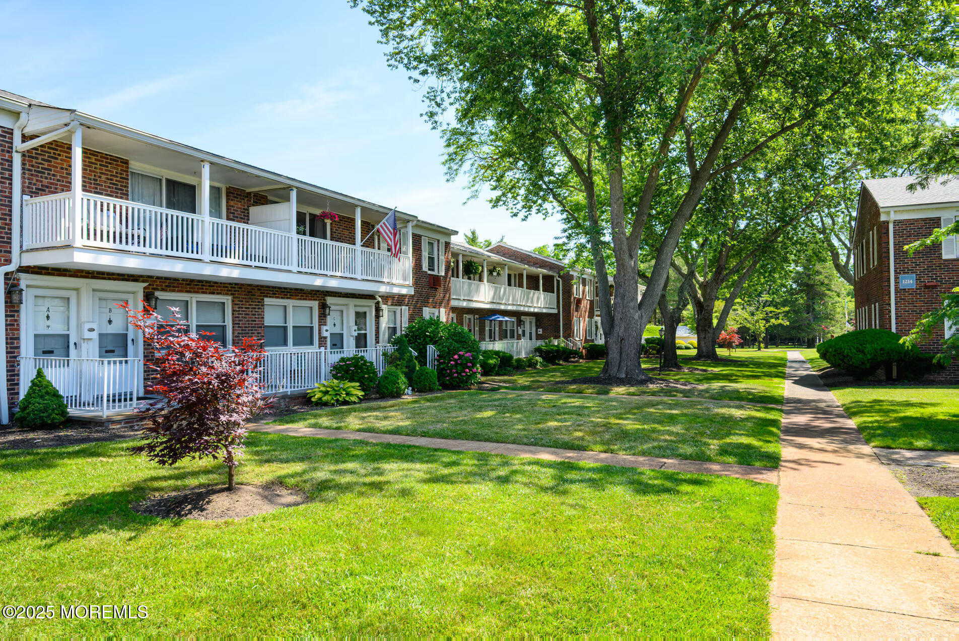 1218 Allaire Road, Unit 1908B Spring Lake, NJ 07762 - Photo 5 of 10 a front view of a building with a garden
