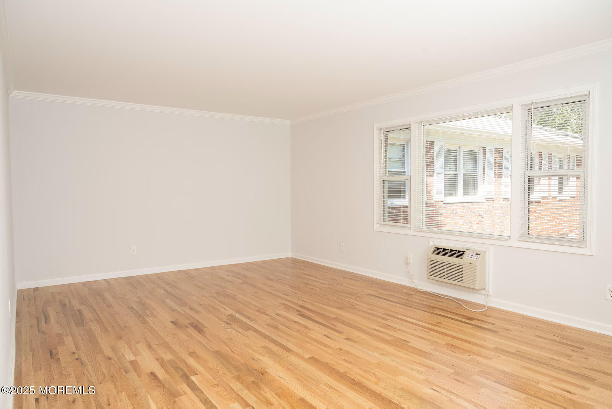1218 Allaire Road, Unit 1908B Spring Lake, NJ 07762 - Photo 9 of 10 a view of empty room with wooden floor and fan