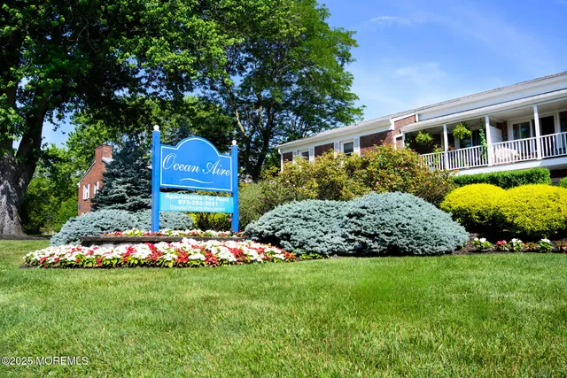 a front view of a house with a yard and potted plants