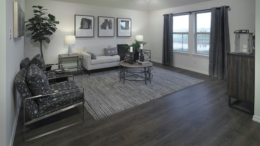 3100 Charleston Drive Ennis, TX 75119 - Photo 16 of 23 Spacious room featuring wood-finish flooring and a series of windows
