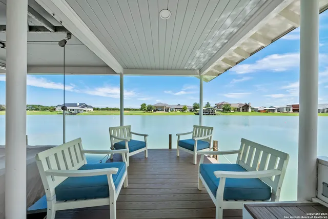 a view of balcony with couch and chairs