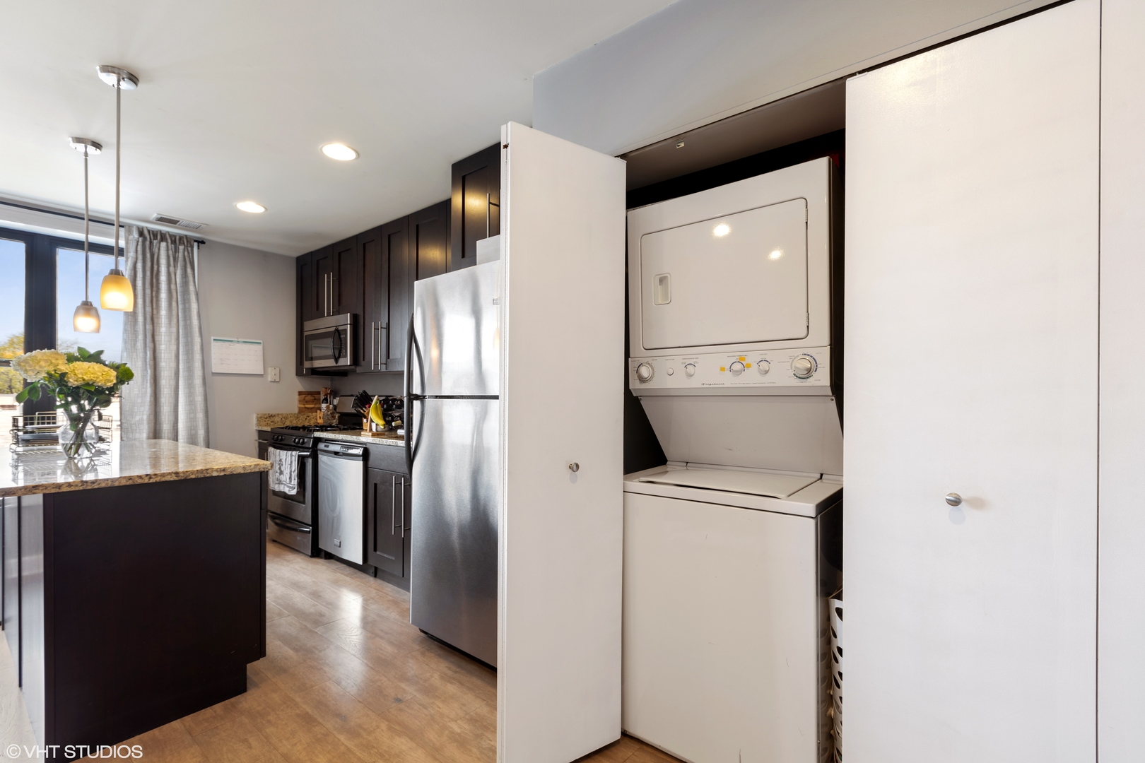 1600 North Halsted Street, Unit 2J Chicago, IL 60614 - Photo 3 of 11 a kitchen with stainless steel appliances a refrigerator and a stove