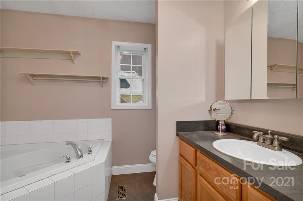 6144 Soco Road Maggie Valley, NC 28751 - Photo 15 of 23 a bathroom with a sink and a toilet