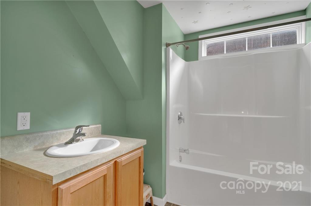 6144 Soco Road Maggie Valley, NC 28751 - Photo 18 of 23 a bathroom with a sink and a mirror