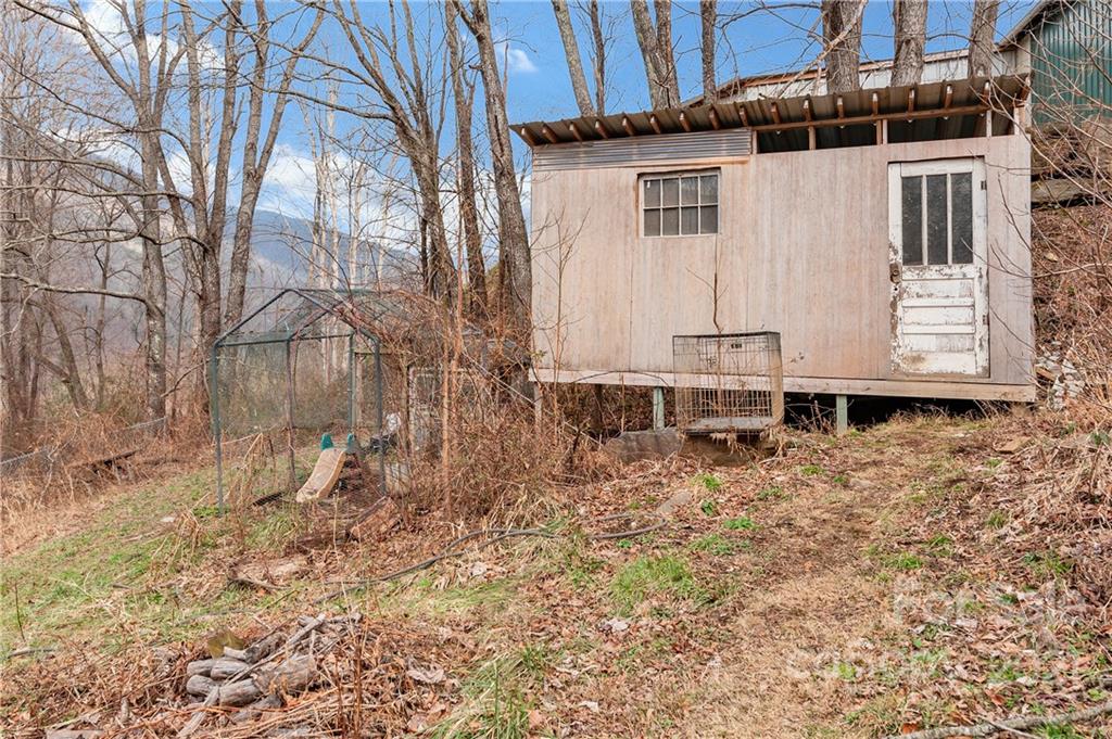 6144 Soco Road Maggie Valley, NC 28751 - Photo 22 of 23 a backyard of a house with large trees