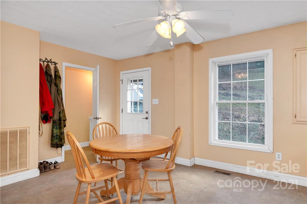 6144 Soco Road Maggie Valley, NC 28751 - Photo 4 of 23 a view of a dining room with furniture and chandelier