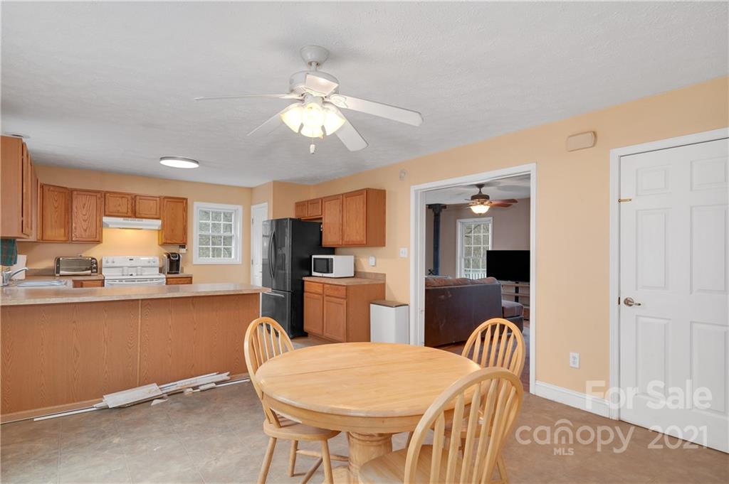 6144 Soco Road Maggie Valley, NC 28751 - Photo 5 of 23 a view of a dining room with furniture and wooden floor