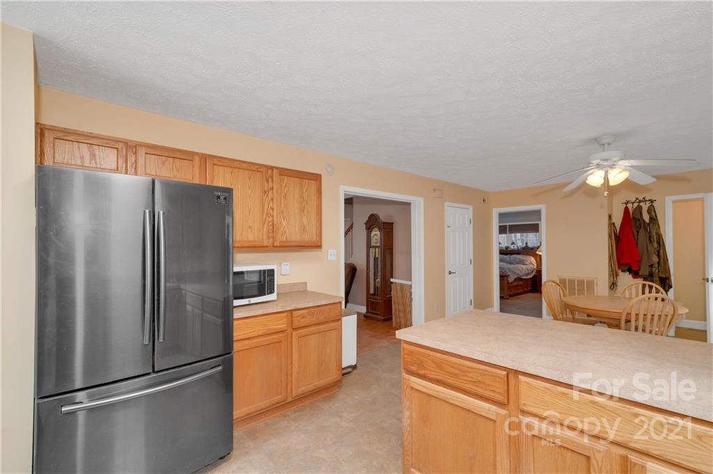 6144 Soco Road Maggie Valley, NC 28751 - Photo 6 of 23 a kitchen with stainless steel appliances a refrigerator and a sink