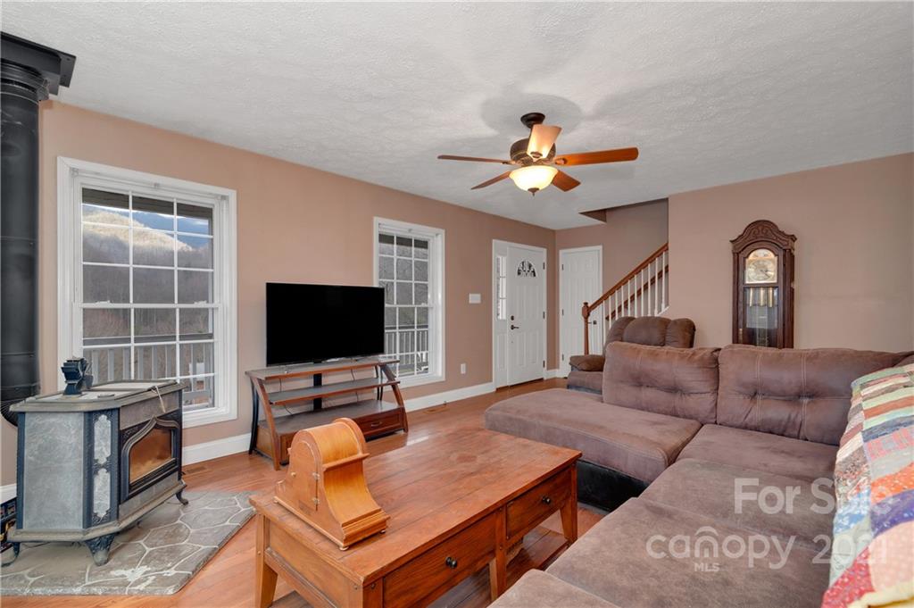 6144 Soco Road Maggie Valley, NC 28751 - Photo 10 of 23 a living room with furniture and a flat screen tv with wooden floor