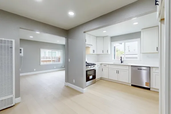 a kitchen with white cabinets and a stove