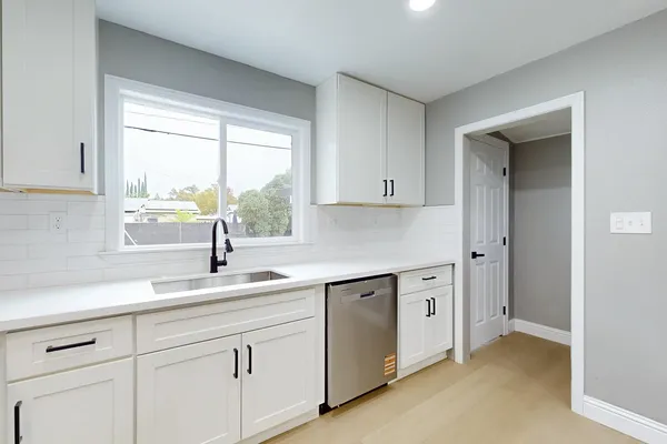 a kitchen with stainless steel appliances granite countertop a stove and a refrigerator