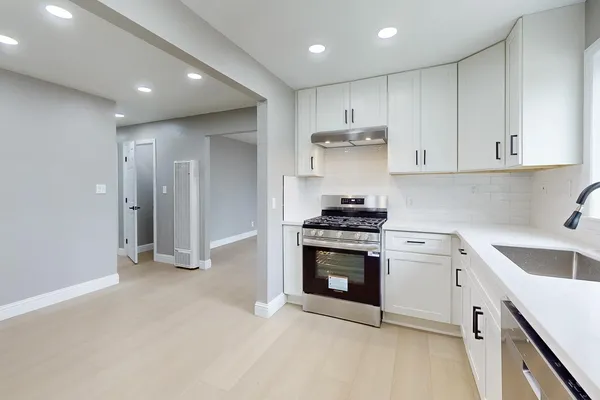 an empty room with closet and mirror