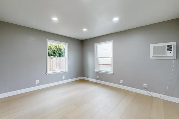 an empty room with windows and closet