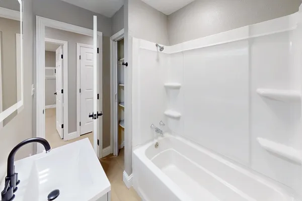 a bathroom with a sink toilet and mirror