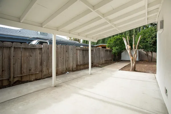a white house that has a tree in front of it