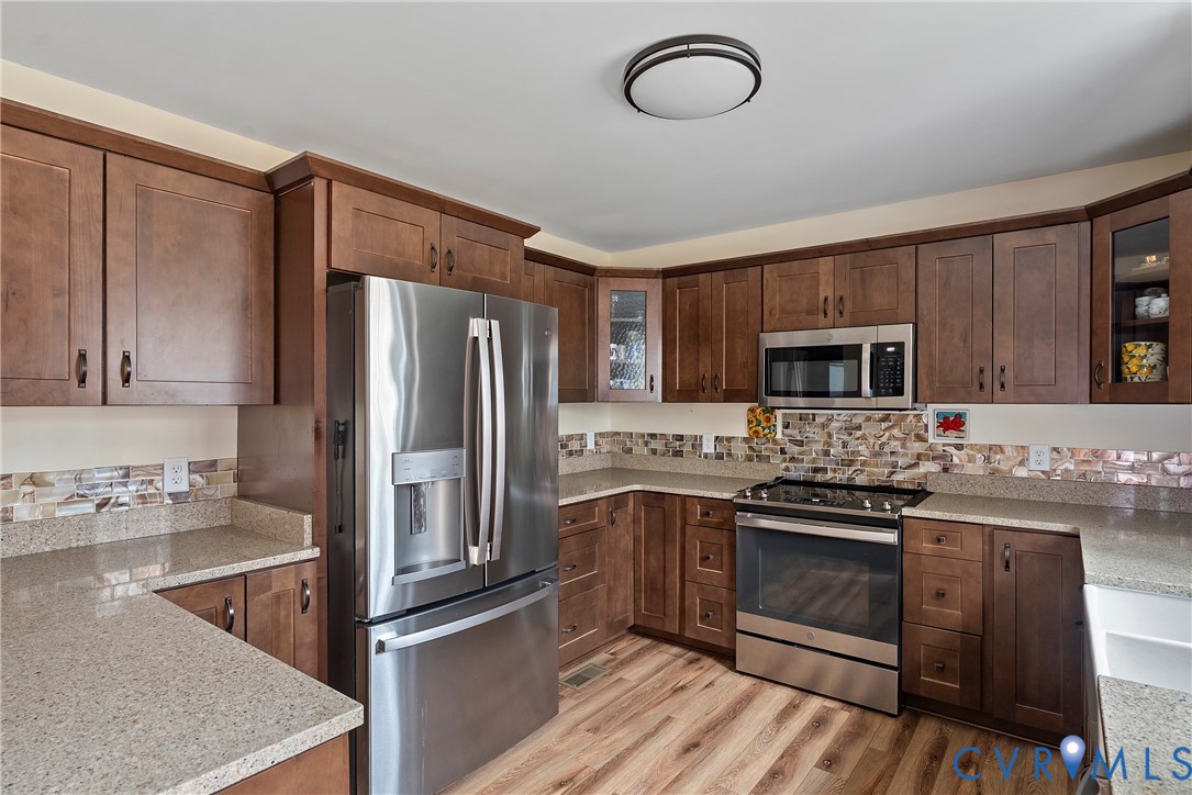 6115 Prospect Road Gloucester, VA 23061 - Photo 16 of 49 a kitchen with stainless steel appliances granite countertop a stove refrigerator sink and microwave