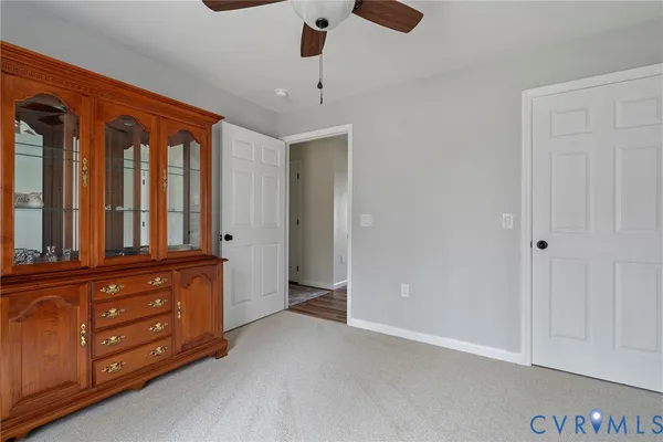 an empty room with window and cabinet