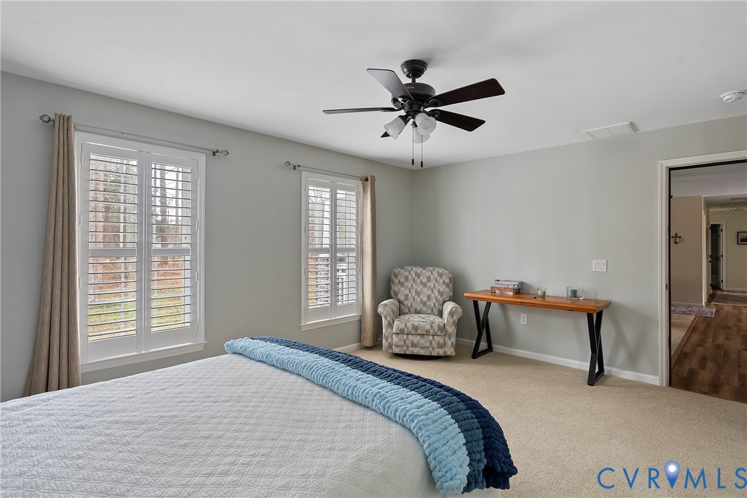 6115 Prospect Road Gloucester, VA 23061 - Photo 26 of 49 a bedroom with a bed and a chandelier