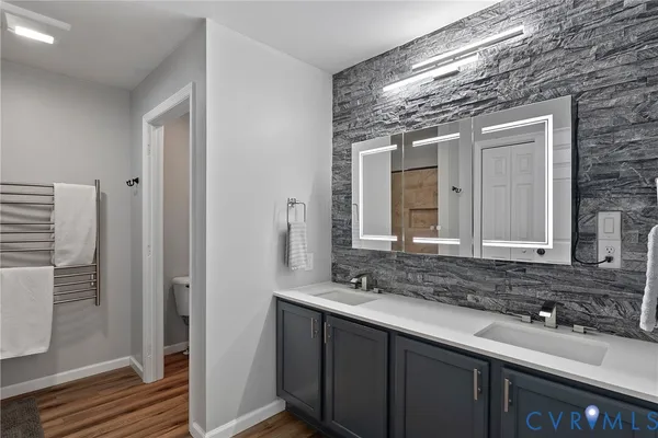 a bathroom with a double vanity sink and a mirror