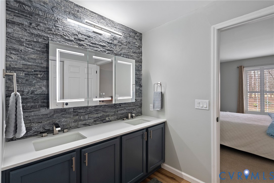 6115 Prospect Road Gloucester, VA 23061 - Photo 30 of 49 a bathroom with a double vanity sink and a mirror