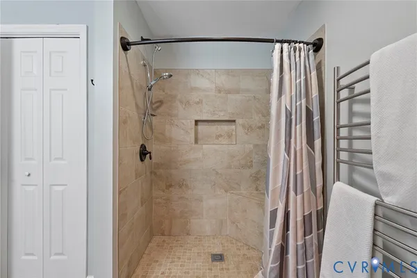 a bathroom with a shower and a glass door