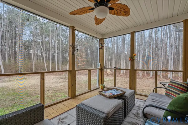 a living room with furniture and a floor to ceiling window