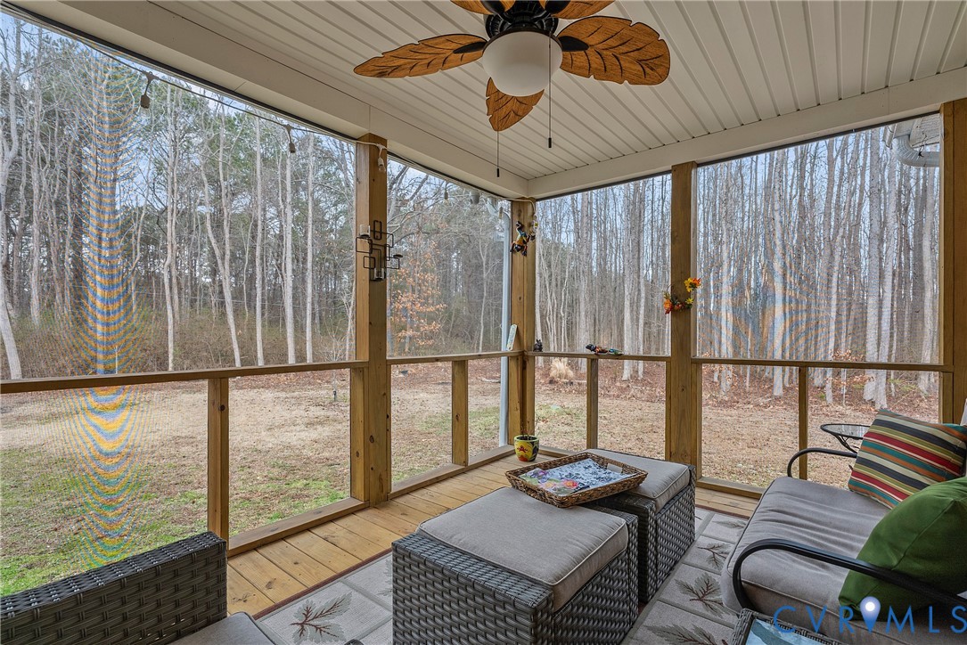 6115 Prospect Road Gloucester, VA 23061 - Photo 37 of 49 a living room with furniture and a floor to ceiling window