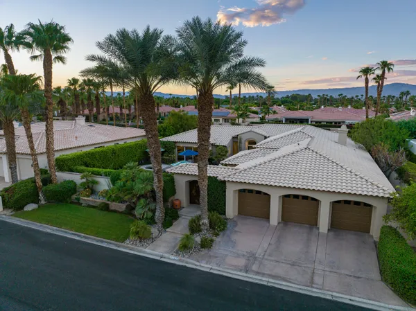 a view of a house with pool backyard and chairs
