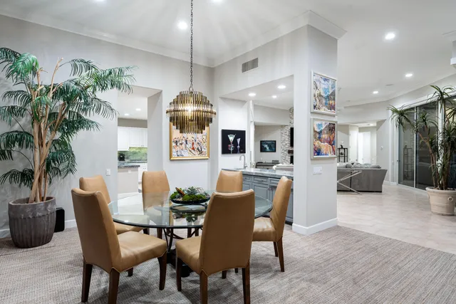 a view of a house with swimming pool and sitting area