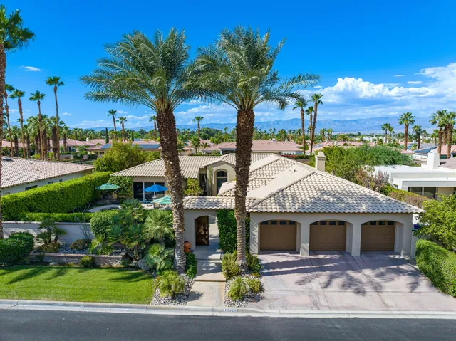 an aerial view of a house with yard swimming pool and outdoor seating