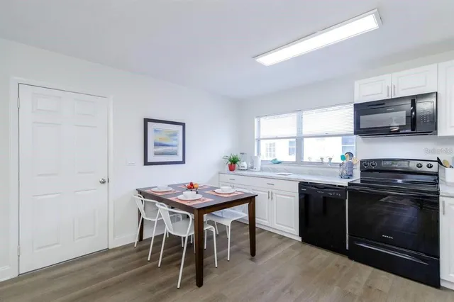 a kitchen with a table and chairs in it
