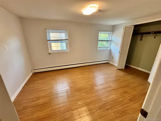 a view of a room with wooden floor and window