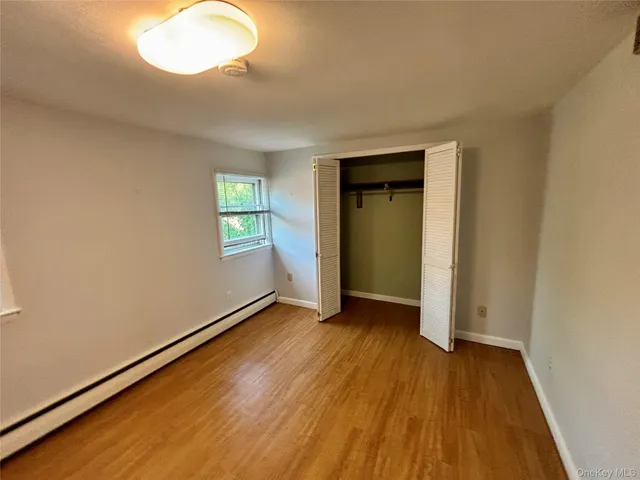 a bathroom with a sink a toilet a mirror and shower