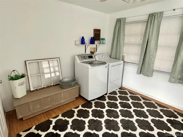 a view of a patio with table and chairs with wooden floor and plants