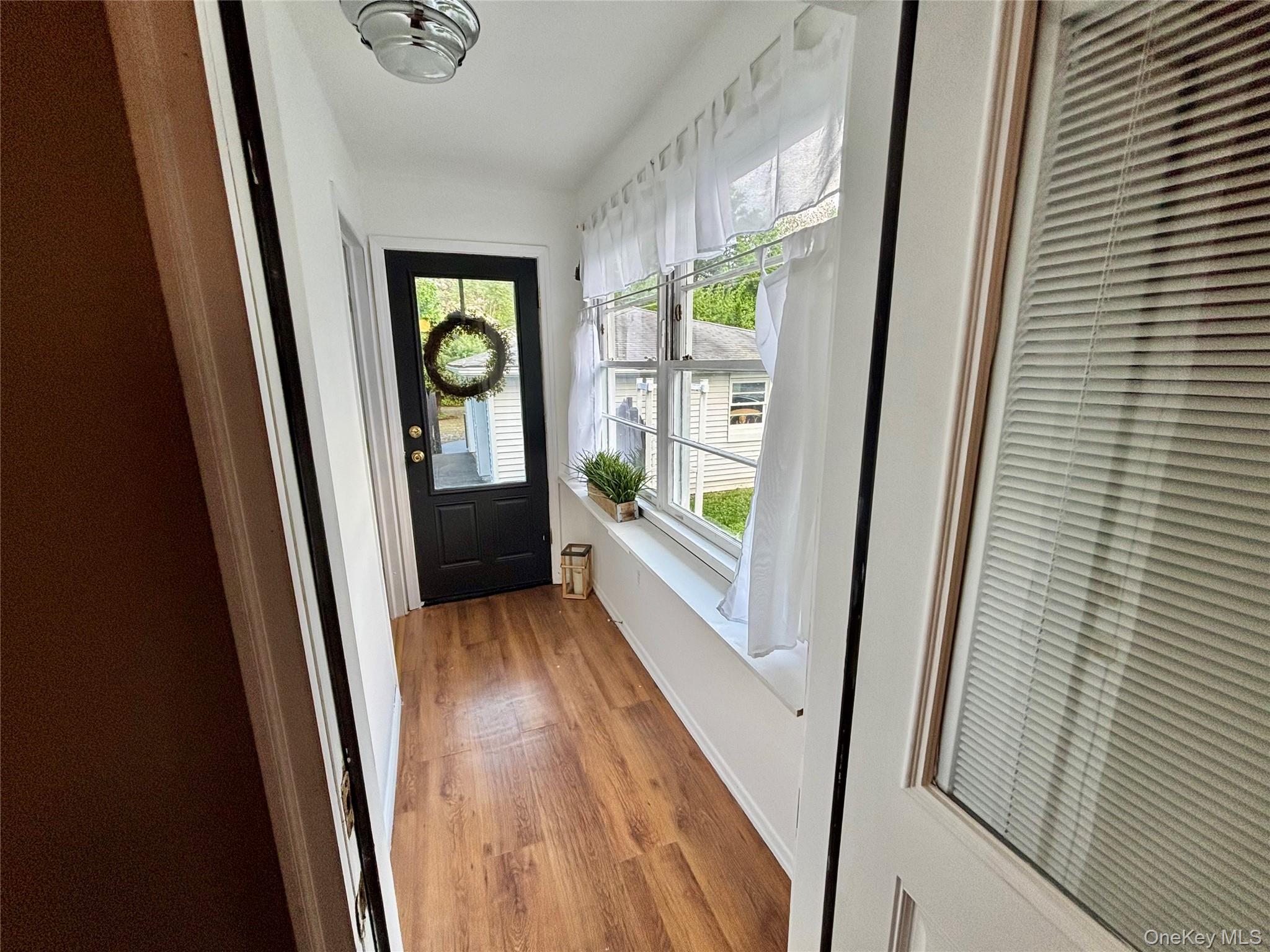 49 North Chestnut Street Beacon, NY 12508 - Photo 26 of 41 Entryway with light wood-style floors, a heating unit, and baseboards