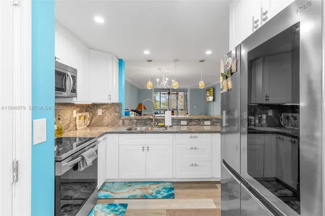 a kitchen with granite countertop stainless steel appliances and counter space