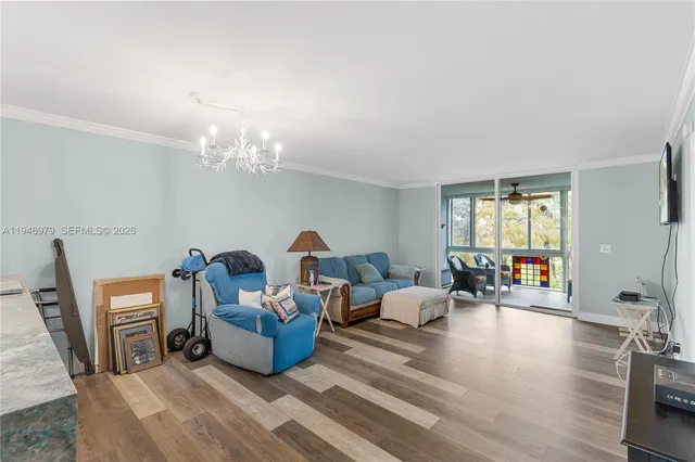 a living room with furniture a window and a chandelier